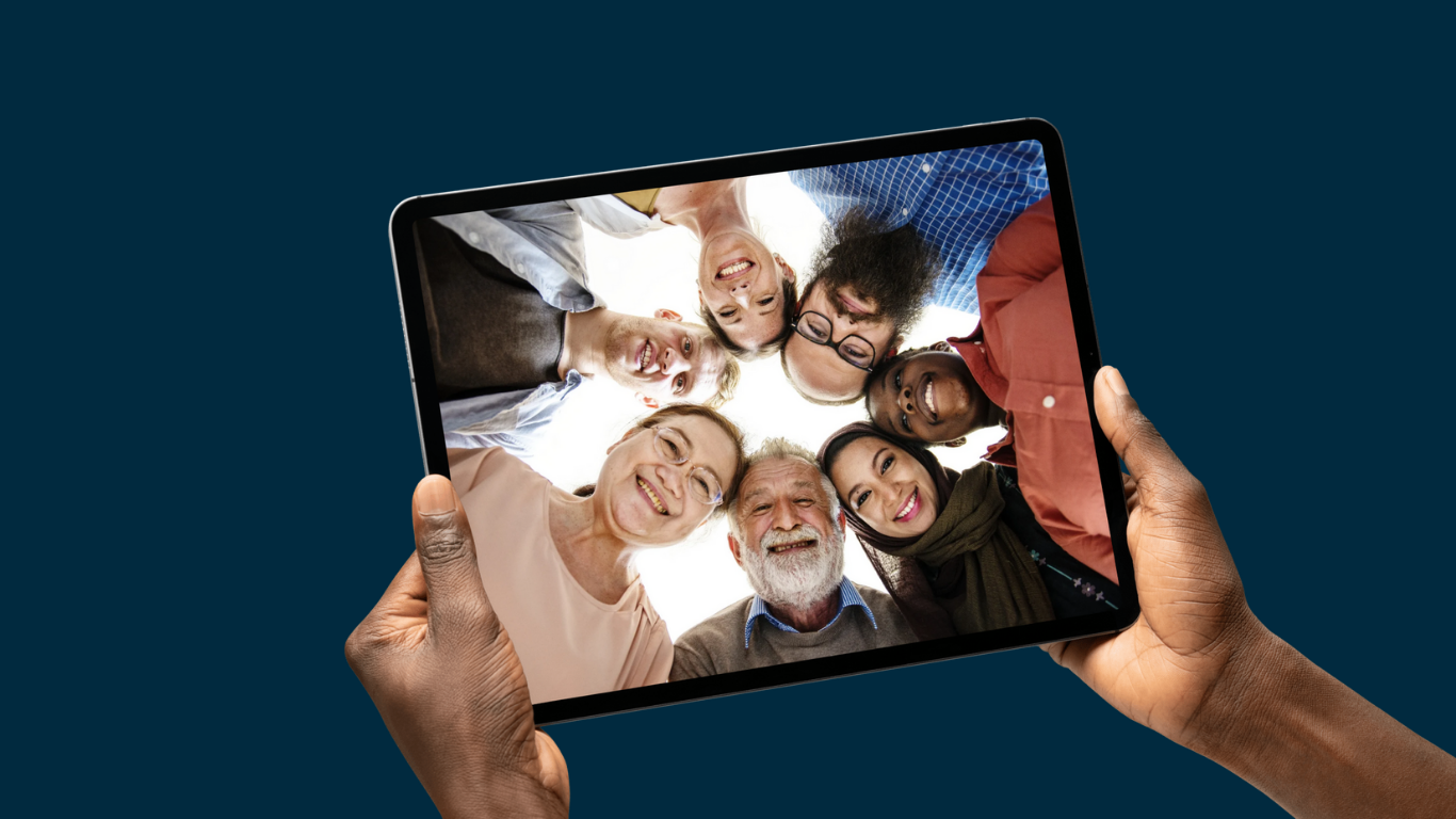 Group of people leaning into a circle for a photo placed in a tablet