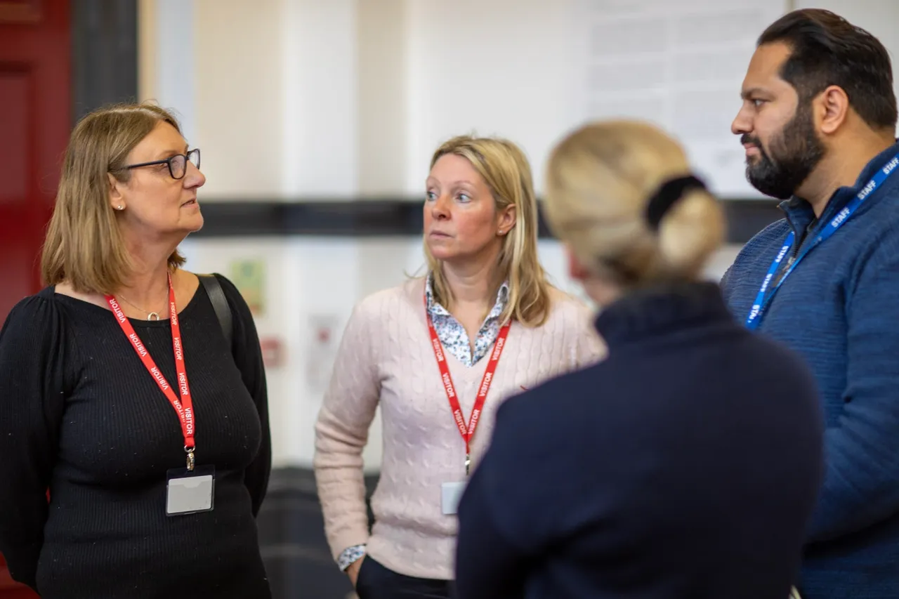 Four people talking together about community clicks